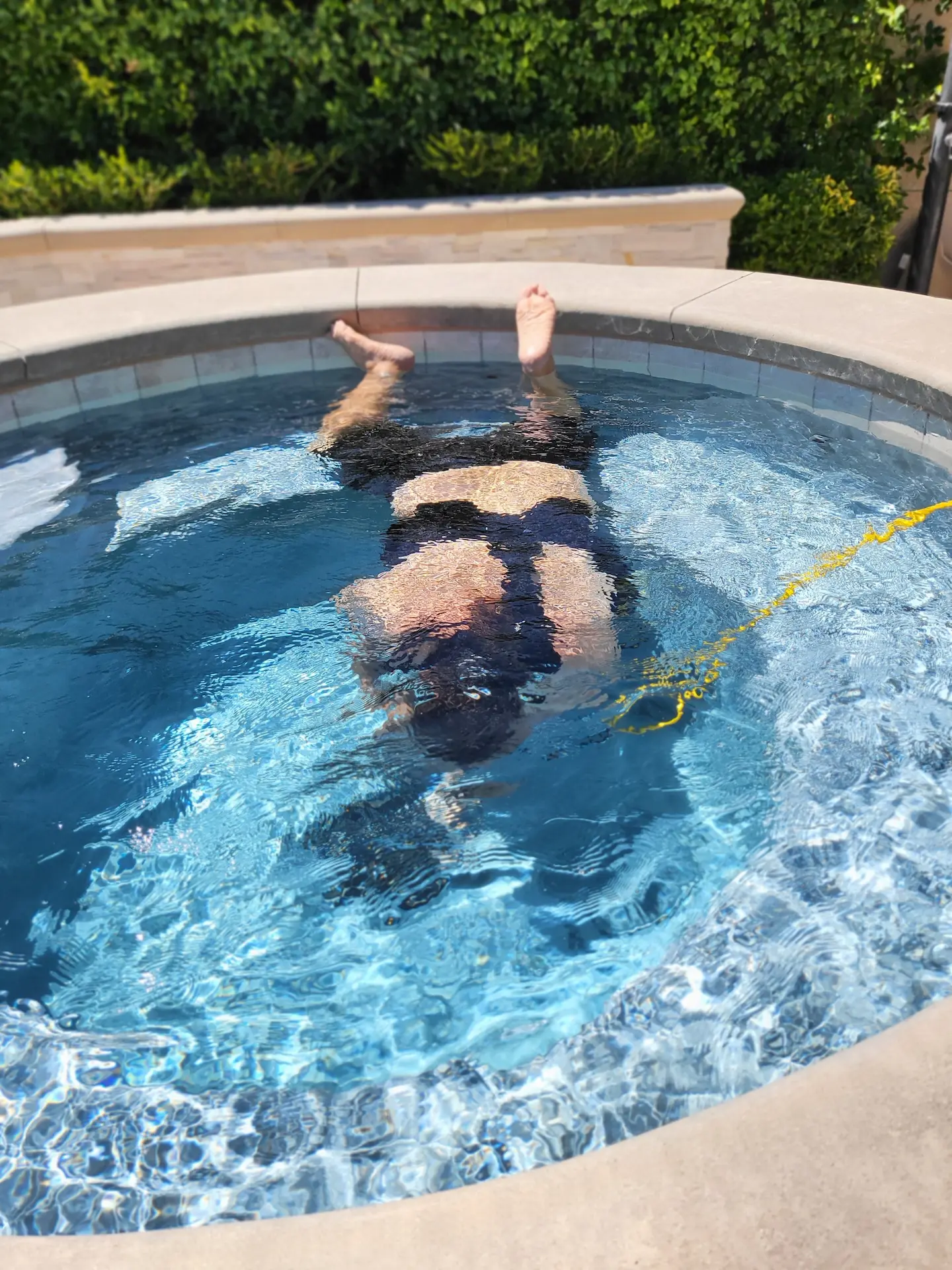 Southern Nevada Leak Detection technician diving underwater to find a pool leak